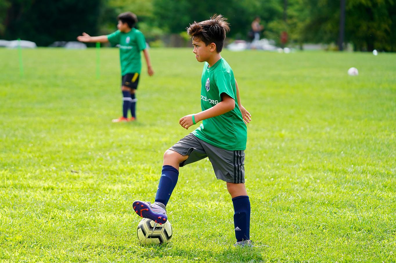 XMD Soccer Academy player on the ball during a small-sided league game